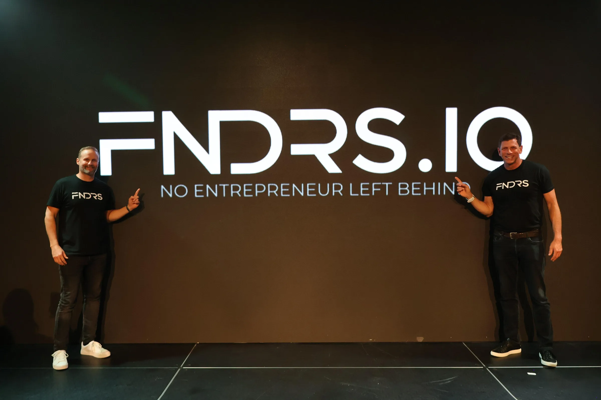 Nick Long and Troy Hoffman at a FNDRS event, reviewing a screen