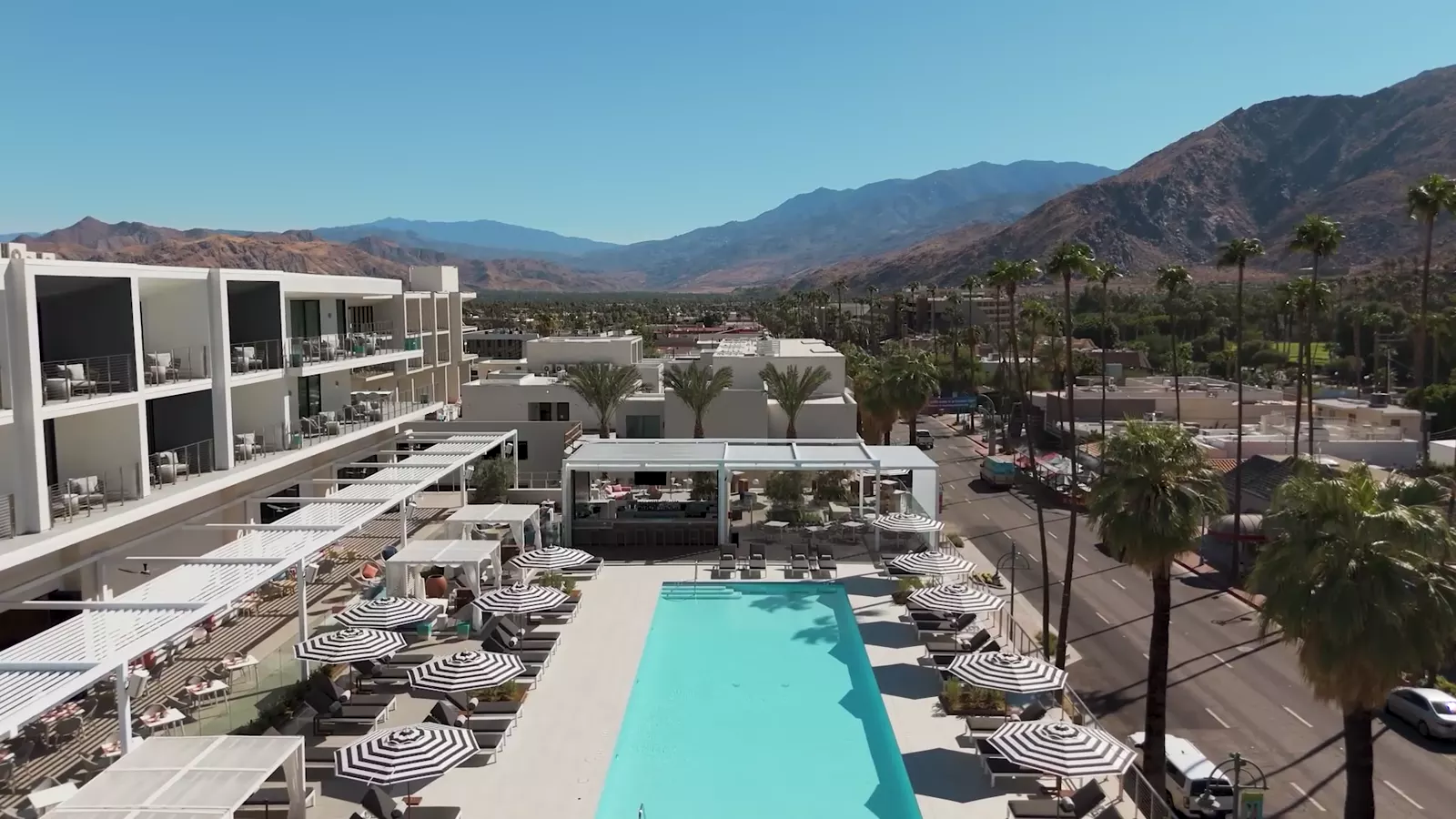 The pool deck at Thompson Palm Springs, the San Jacinto mountains behind it